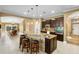 Island kitchen with granite countertops and dark wood cabinets at 524 Quail Hill Dr, Debary, FL 32713