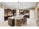 Spacious kitchen featuring granite countertops, dark wood cabinets, and a large island at 524 Quail Hill Dr, Debary, FL 32713