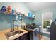 Bright laundry room with shelving, sink, and space for washer and dryer at 524 Quail Hill Dr, Debary, FL 32713