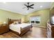 Relaxing main bedroom with lake view and ceiling fan at 524 Quail Hill Dr, Debary, FL 32713