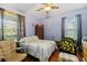 Bedroom with wood floors, ceiling fan, and window at 5423 Swordfern Ct, Port Orange, FL 32128
