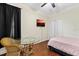 Bedroom with wood floors, small table, and double closet at 5423 Swordfern Ct, Port Orange, FL 32128