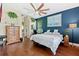 Spacious bedroom with wood floors and large window at 5423 Swordfern Ct, Port Orange, FL 32128