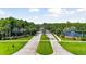 Gated entrance to a community with palm trees and a scenic lake at 5423 Swordfern Ct, Port Orange, FL 32128