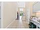 Bright and spacious entryway with tile flooring and a view of the living room at 5423 Swordfern Ct, Port Orange, FL 32128