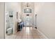 Elegant entryway with tile floor, chandelier, and half bathroom at 5423 Swordfern Ct, Port Orange, FL 32128