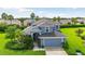 Two-story house with a gray roof, two-car garage, and landscaped yard at 5423 Swordfern Ct, Port Orange, FL 32128