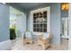 Relaxing front porch with wicker chairs and striped cushions at 5423 Swordfern Ct, Port Orange, FL 32128