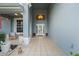 Front porch with tiled floor, wicker chairs, and a view of the front yard at 5423 Swordfern Ct, Port Orange, FL 32128