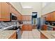 Kitchen boasts granite countertops and stainless steel appliances at 5423 Swordfern Ct, Port Orange, FL 32128