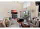 Spacious living room with hardwood floors, comfy seating, and a large TV at 5423 Swordfern Ct, Port Orange, FL 32128