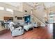 Two-story living room with hardwood floors, comfortable seating and kitchen views at 5423 Swordfern Ct, Port Orange, FL 32128