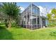 Expansive screened patio with lush landscaping views at 5423 Swordfern Ct, Port Orange, FL 32128
