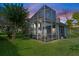 Spacious screened patio at sunset, providing a tranquil atmosphere at 5423 Swordfern Ct, Port Orange, FL 32128