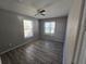 Cozy bedroom with gray walls, wood-look flooring, and ceiling fan at 610 Division St, Daytona Beach, FL 32114