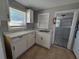 Small kitchen with white cabinets, marble countertops, and tile floor at 610 Division St, Daytona Beach, FL 32114