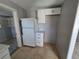 Compact kitchen area with white cabinets and a refrigerator at 610 Division St, Daytona Beach, FL 32114