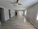 Bright living room featuring gray walls, wood-look floors, and ceiling fan at 610 Division St, Daytona Beach, FL 32114