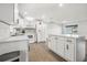 Bright kitchen with white cabinets, quartz countertops and breakfast bar at 612 Moonpenny Cir, Port Orange, FL 32127