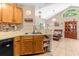 Kitchen with oak cabinets, double sink, and breakfast bar at 963 Helmsley Ct # 207, Lake Mary, FL 32746
