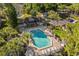 Community pool and clubhouse with surrounding lush greenery at 963 Helmsley Ct # 207, Lake Mary, FL 32746