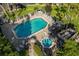 Community pool and spa with plenty of lounge chairs at 963 Helmsley Ct # 207, Lake Mary, FL 32746