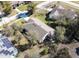 Aerial view of a single-story house with a large yard and solar panels on a nearby house at 981 Wilmington Dr, Deltona, FL 32725