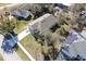 An aerial shot showcases the property's roof and expansive backyard, complete with a long driveway at 981 Wilmington Dr, Deltona, FL 32725