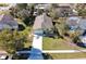 An aerial view of the house with lush greenery, mature trees, and a long driveway at 981 Wilmington Dr, Deltona, FL 32725