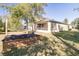 Expansive backyard featuring a screened-in porch and mature trees, offering a private outdoor space at 981 Wilmington Dr, Deltona, FL 32725