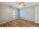 Bright bedroom with wood-look floors and ceiling fan at 981 Wilmington Dr, Deltona, FL 32725