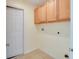 Laundry room with wood cabinets and tile floor at 981 Wilmington Dr, Deltona, FL 32725