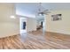 Open living room with wood-look floors and neutral walls at 981 Wilmington Dr, Deltona, FL 32725