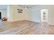 Open living room with wood-look floors and access to bathroom at 981 Wilmington Dr, Deltona, FL 32725