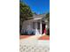 Front view of a light gray house with red door and landscaping at 101 N Hill Ave # 11, Deland, FL 32724