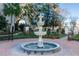 Ornate fountain in a landscaped courtyard with brick walkways at 1100 Delaney Ave # F200, Orlando, FL 32806