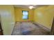 Large bedroom with yellow walls and window with curtains at 11346 Circle Way, Leesburg, FL 34788