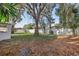 Large backyard with a privacy fence and mature oak tree at 118 N Sunland Dr, Sanford, FL 32773