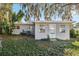 Features a detached studio and a large oak tree at 118 N Sunland Dr, Sanford, FL 32773