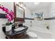 Modern bathroom boasts a soaking tub, marble tile, and updated fixtures at 118 N Sunland Dr, Sanford, FL 32773