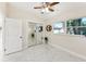 Bedroom with mirrored closet, marble floors, and white door at 118 N Sunland Dr, Sanford, FL 32773
