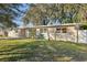 Ranch style home with a large front yard and mature oak trees at 118 N Sunland Dr, Sanford, FL 32773