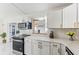 Modern kitchen with white cabinets and quartz countertops at 118 N Sunland Dr, Sanford, FL 32773