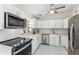 Modern white kitchen with stainless steel appliances at 118 N Sunland Dr, Sanford, FL 32773
