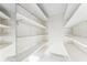 Empty storage room with white shelves and mirrored wall at 118 N Sunland Dr, Sanford, FL 32773