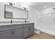 Modern bathroom featuring a double vanity with granite countertop and a walk-in shower at 1205 2Nd St, Orange City, FL 32763