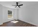 Bright bedroom with ceiling fan and a window overlooking the backyard at 1205 2Nd St, Orange City, FL 32763
