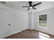 Bedroom featuring a ceiling fan, closet, and a window overlooking the backyard at 1205 2Nd St, Orange City, FL 32763