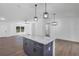 Open-concept kitchen with granite island that flows into the living area at 1205 2Nd St, Orange City, FL 32763
