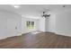 Bright living room featuring sleek floors, modern ceiling fan, and ample natural light at 1205 2Nd St, Orange City, FL 32763